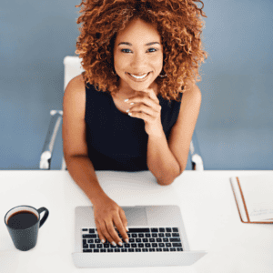 Time-poor Brisbane professional smiling while working remotely after cosmetic dental treatment